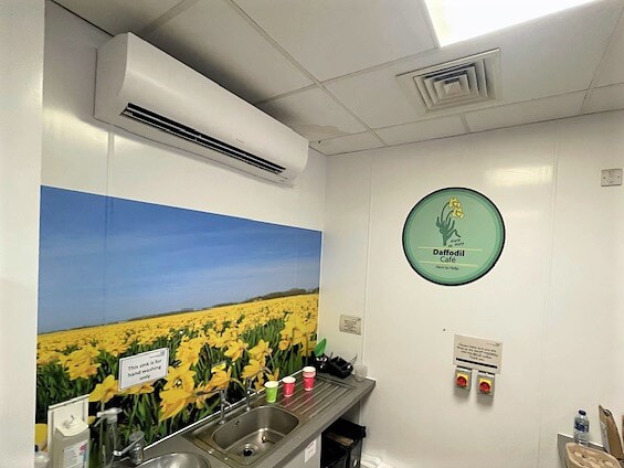 An image of a yellow floral wall graphic at NHS Sherwood Forest Hospital.